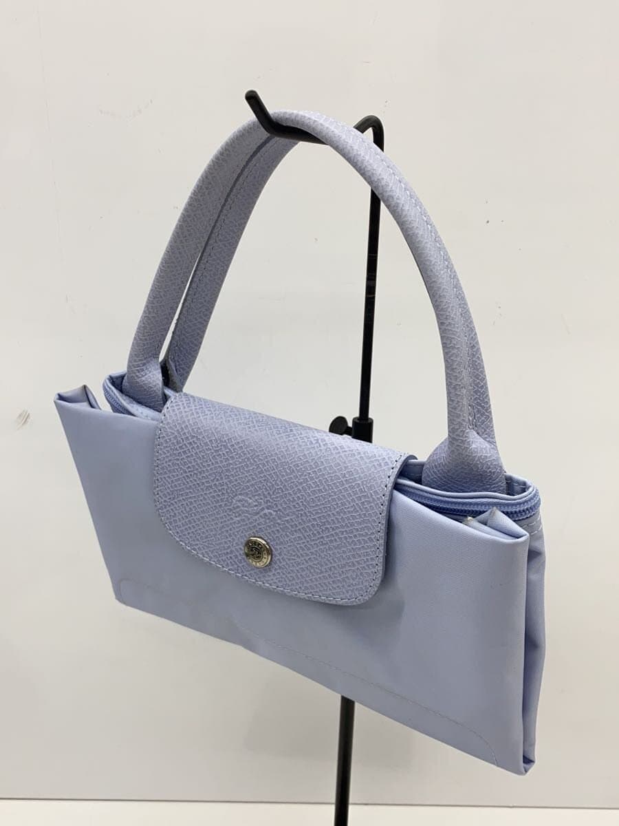 There are stains on the inside of the LONGCHAMP. 2