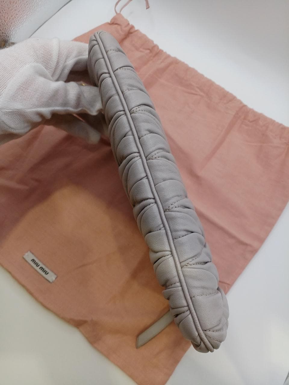 Matelassé clutch bag in greige 9