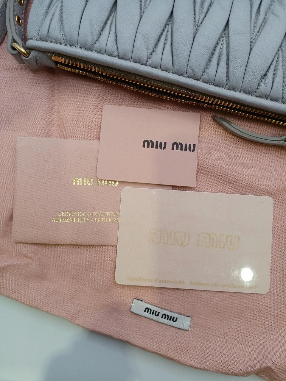 Matelassé clutch bag in greige 12